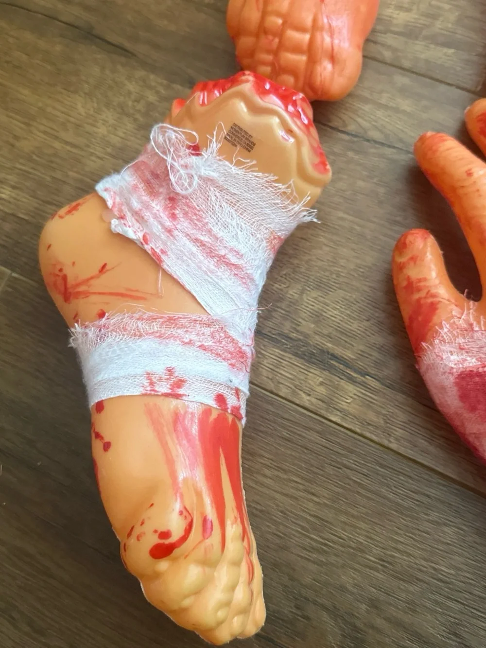Fake Severed Hand and Foot Halloween Props - Bloody Orange Set
